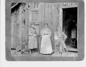 Three People in Front of a House