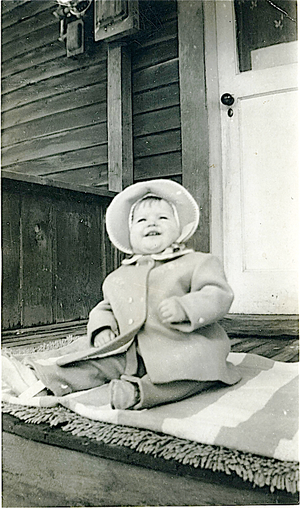 Pam Doan as a child on family house porch